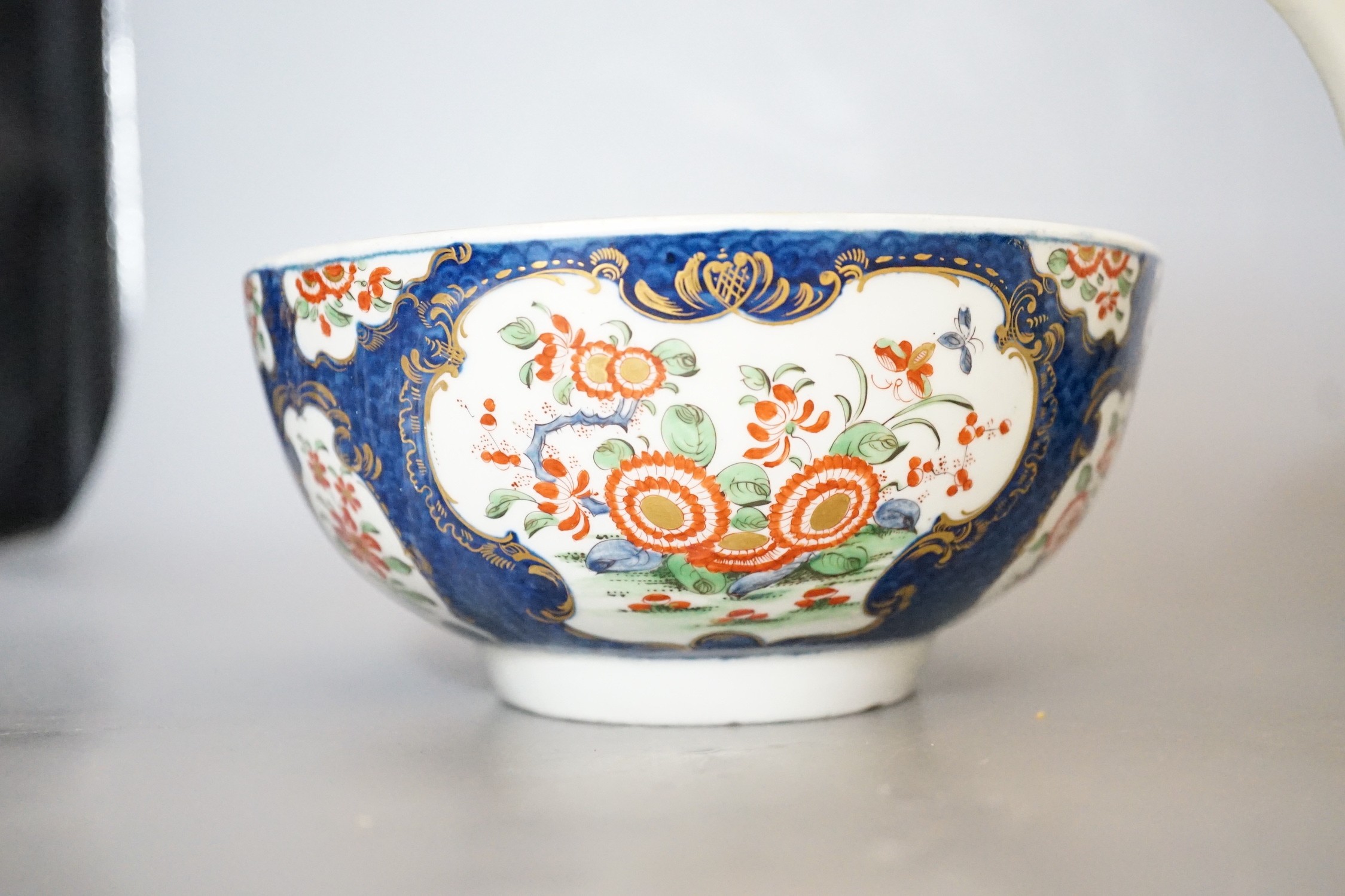 A Worcester teapot and cover, painted in the manner of the red line border group with the Queens pattern and a Worcester blue scale bowl painted with kakiemon flowers, teapot and cover 16cms high